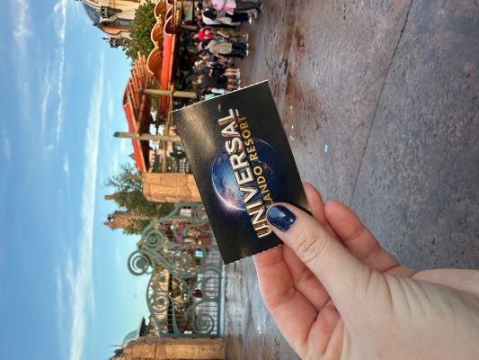 Printed Universal Orlando park ticket held in front of theme park entrance