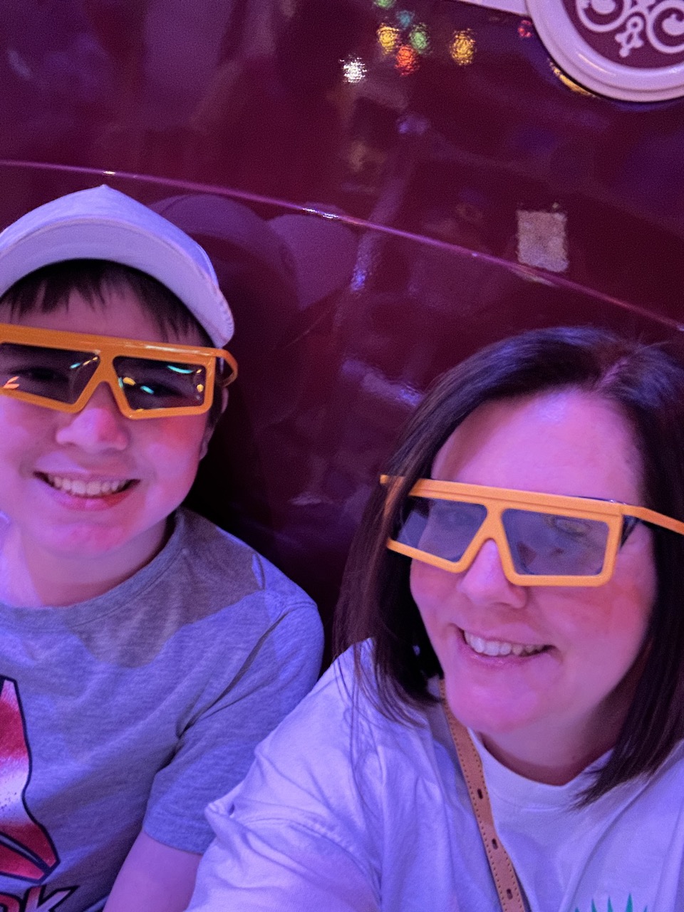 Teenager and parent wearing 3D glasses on a Walt Disney World attraction